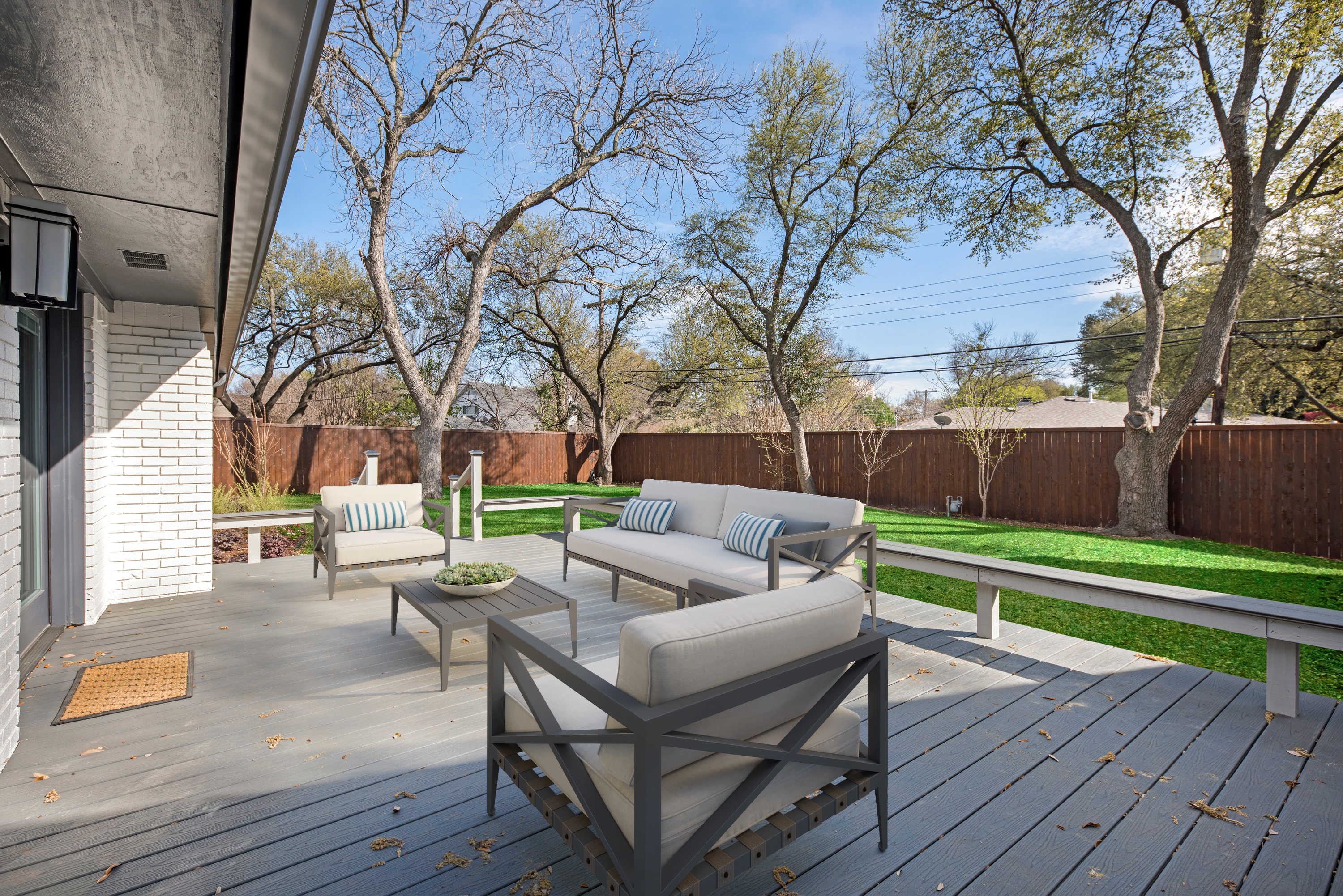 real estate photography of wood deck and patio area